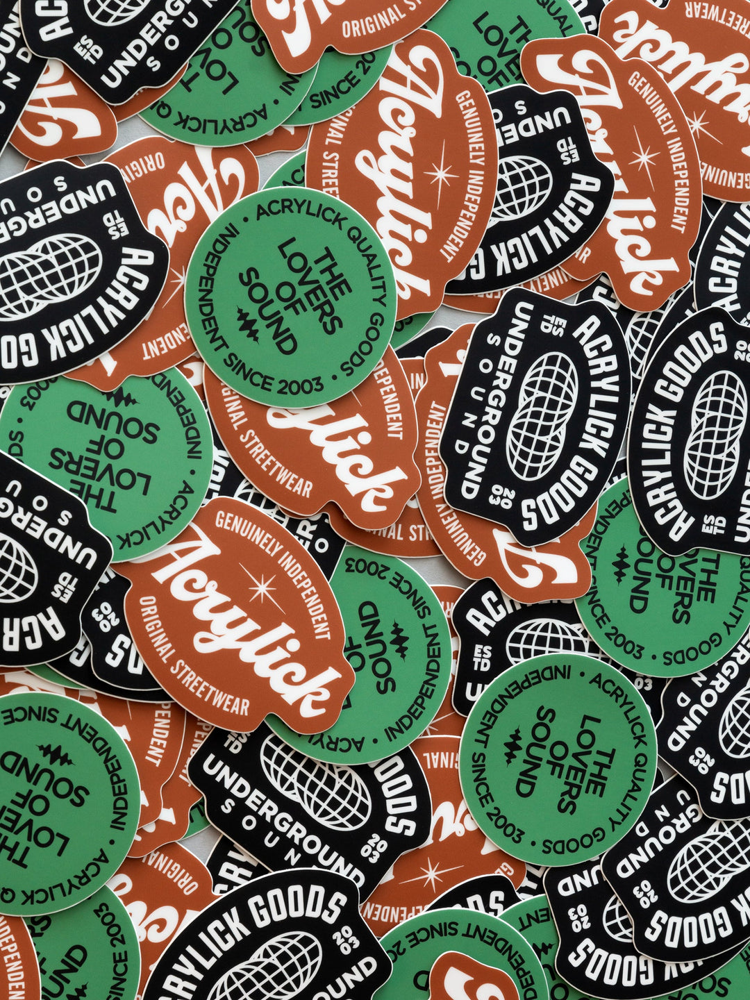 A dense, overlapping pile of die-cut stickers featuring the &
