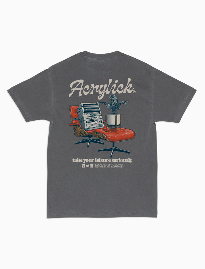 Mid-century style lounge chair holding a vintage hi-fi stereo, paired with a peace lily in a modern planter, representing relaxed listening and thoughtful living.