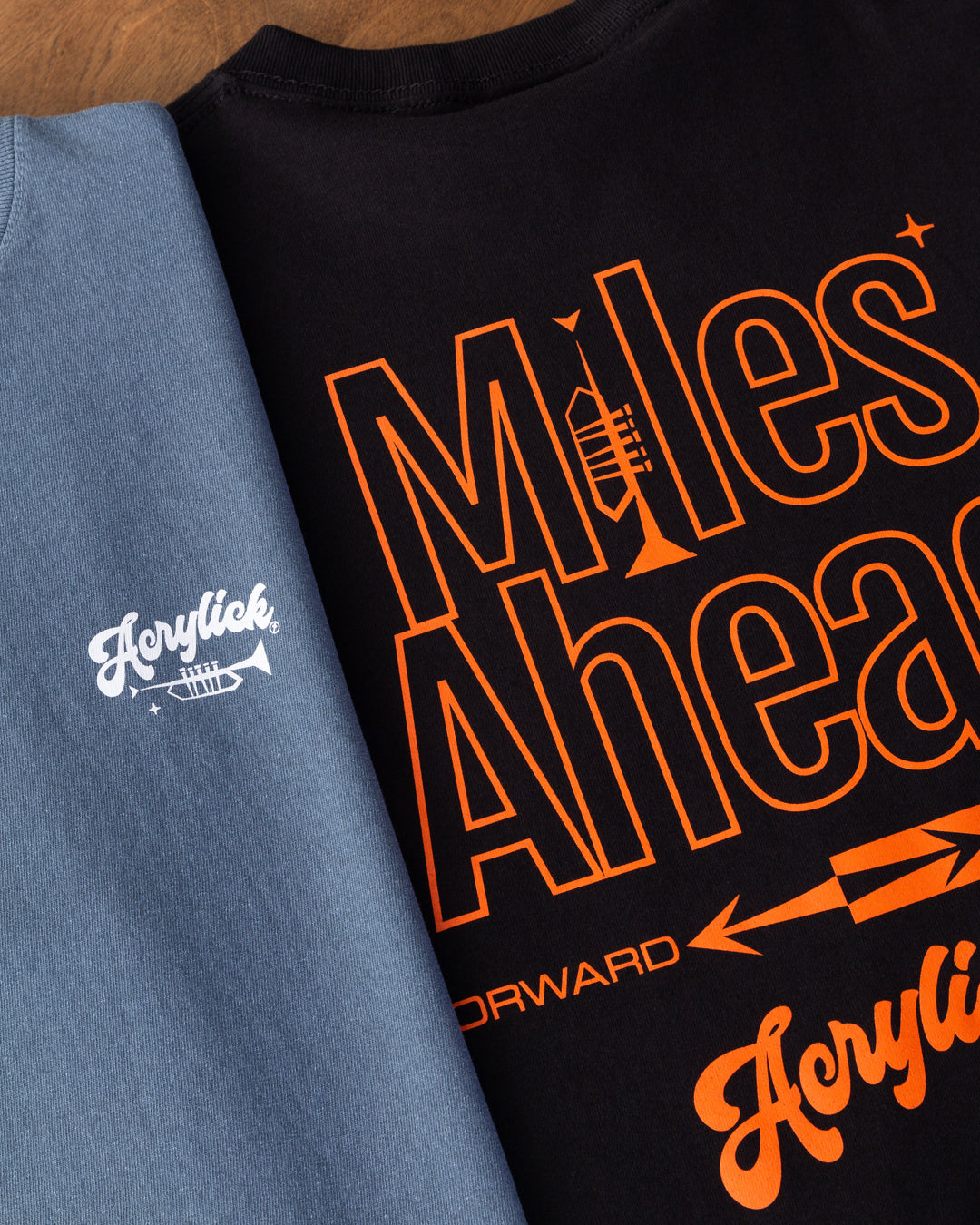 Minimal graphic featuring a trumpet forming the letter “I” in “Miles,” with mid-century arrows pointing forward to represent progress and forward thinking.