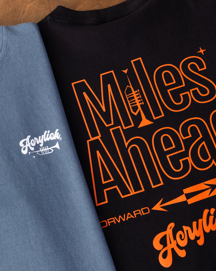 Minimal graphic featuring a trumpet forming the letter “I” in “Miles,” with mid-century arrows pointing forward to represent progress and forward thinking.