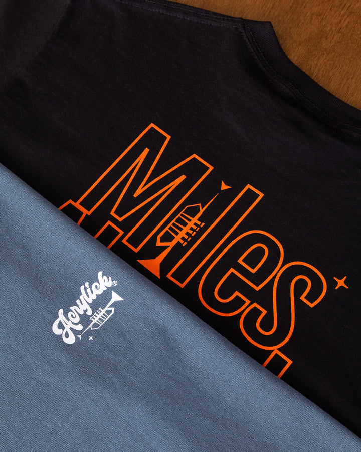 Minimal graphic featuring a trumpet forming the letter “I” in “Miles,” with mid-century arrows pointing forward to represent progress and forward thinking.