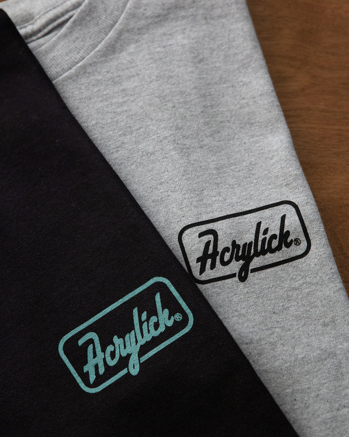 Retro script-style badge logo reading “Acrylick” and “Quality Goods,” inspired by classic signage and heritage branding.