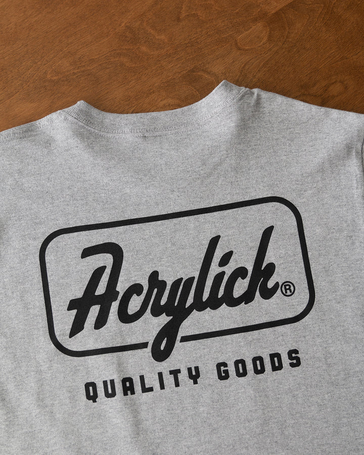 Retro script-style badge logo reading “Acrylick” and “Quality Goods,” inspired by classic signage and heritage branding.