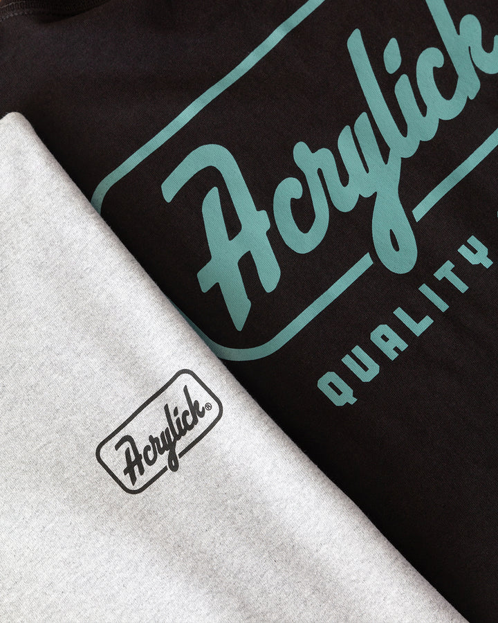 Retro script-style badge logo reading “Acrylick” and “Quality Goods,” inspired by classic signage and heritage branding.