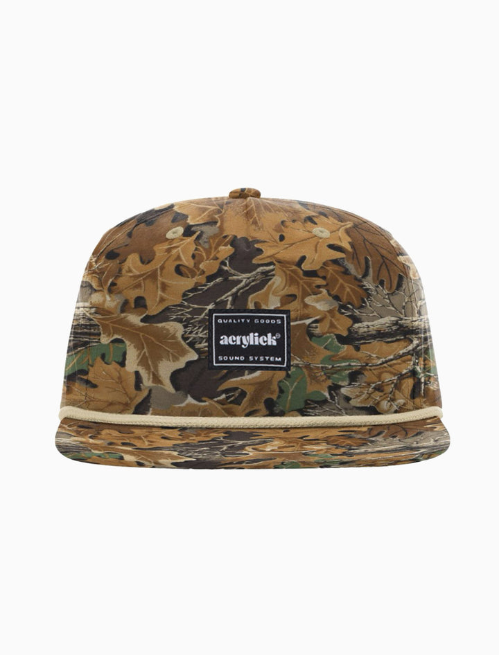 Camouflage-patterned snapback with rope on front bill with our Sound System woven label front center.